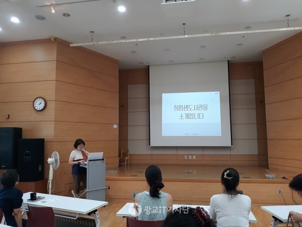 희망샘 도서관을 소개하고 있는 생명밥상 홍영남 활동가의 모습